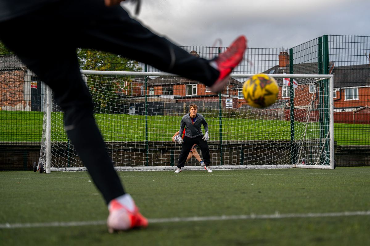 A goalkeeper facing a shot on the Northwood 3G pitch
