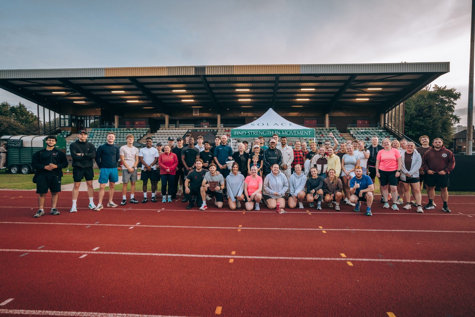 Runners at Track Social in front of the grandstand